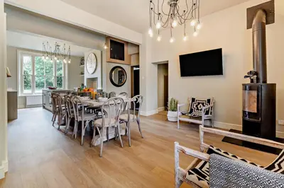 a dining room and living room with a table and chairs at 6 Bed in Cowlinge oc-b32762 in Cowlinge
