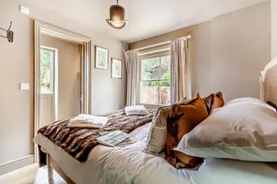 a bedroom with a large bed with a window at 6 Bed in Cowlinge oc-b32762 in Cowlinge