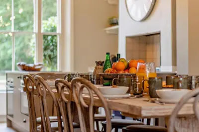 a wooden table with chairs in a kitchen with fruit on it at 6 Bed in Cowlinge oc-b32762 in Cowlinge