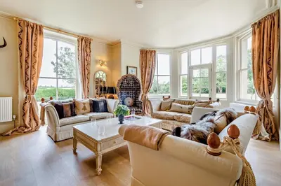 a living room with a dog laying on a couch at 6 Bed in Cowlinge oc-b32762 in Cowlinge