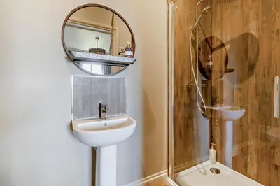 a bathroom with a sink and a mirror and a shower at 6 Bed in Cowlinge oc-b32762 in Cowlinge
