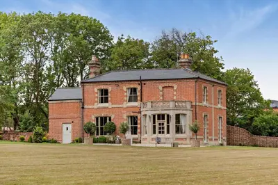 an old red brick house with a grass field at 6 Bed in Cowlinge oc-b32762 in Cowlinge