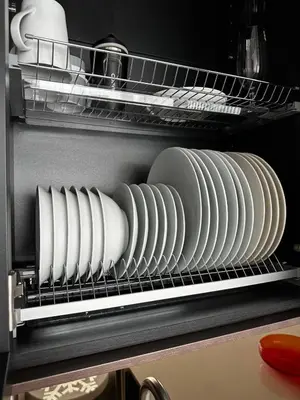 a rack with plates and dishes in a refrigerator at Canewdon Rd Luxury Accommodation in Westcliff On Sea