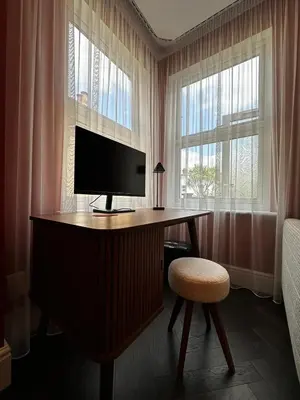 a bedroom with a desk with a television and a stool at Canewdon Rd Luxury Accommodation in Westcliff On Sea