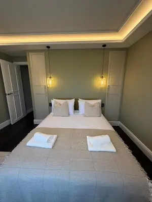 a bedroom with a large bed with two white pillows at Canewdon Rd Luxury Accommodation in Westcliff On Sea