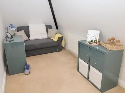 a living room with a couch and a table at Old Felixstowe, Bath Road in Felixstowe
