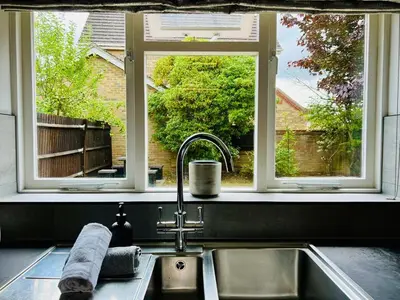 a kitchen with a sink and a window and a sink at Luxury Homely Stay Near City Centre With Parking in Colchester