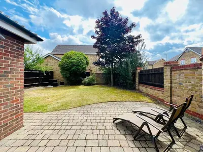 a bench sitting on a brick patio in a yard at Luxury Homely Stay Near City Centre With Parking in Colchester