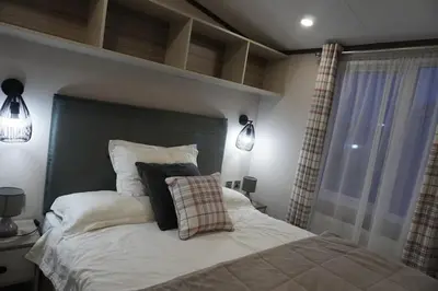 a bedroom with a large bed and a window at Neptune in Parkeston