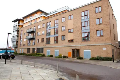 a large brick building on the side of a street at Spacious 2-Bed Flat in Homerton House in Cambridge