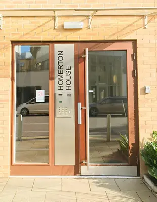 an entrance to a building with a revolving door at Spacious 2-Bed Flat in Homerton House in Cambridge