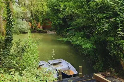 a small boat in a river with trees at Bears House in Westley Waterless