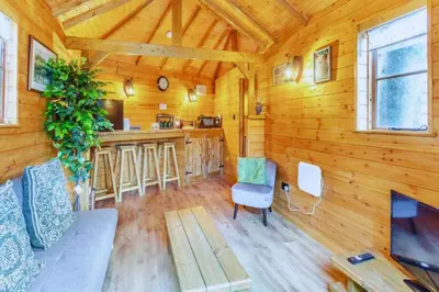 a living room with a couch and a table at Bears House in Westley Waterless