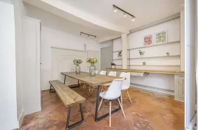 a dining room with a wooden table and white chairs at 6 Angel Hill, Bury st Edmunds in Bury Saint Edmunds
