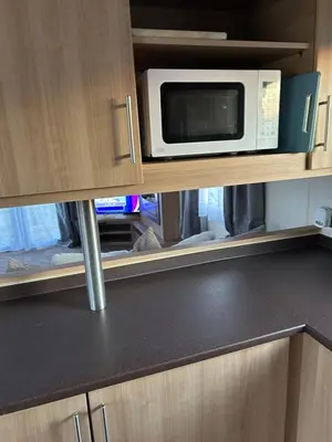 a microwave oven sitting on top of a kitchen counter at 2 Bedroom caravan in Saint Osyth