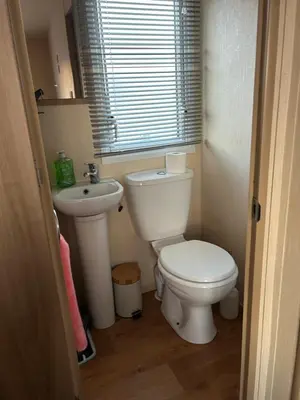 a small bathroom with a toilet and a sink at 2 Bedroom caravan in Saint Osyth