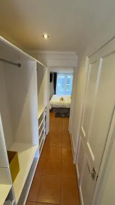 a hallway with a bedroom and a bed in a room at Peaceful Springfield Studio in Chelmsford