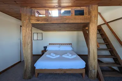 a bedroom with a bed with two pillows on it at Grapnells Lodge, Wallasea Island, Rochford, Essex in Rochford