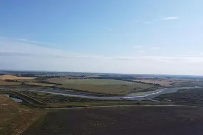 an aerial view of a river in a field at Grapnells Lodge, Wallasea Island, Rochford, Essex in Rochford