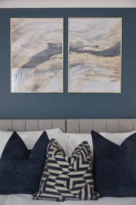 two pictures on the wall above a couch with pillows at Cosy Luxe 3Bed Retreat Hot Tub BBQ Parking Near Town Perfect for Contractors Families Short & Long Stay in Hythe
