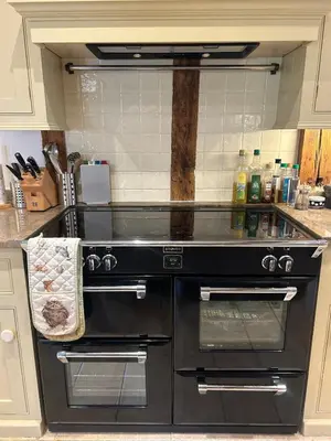 a kitchen with a black oven in a kitchen at Heritage Cottage with a Pool in Diss