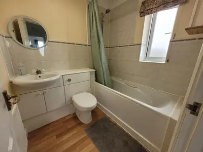 a bathroom with a sink and a toilet and a bath tub at Seaview house - Three bedroom house with close access to beach by Catchpole Stays in Clacton-on-Sea