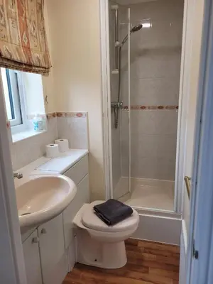 a bathroom with a shower and a toilet and a sink at Seaview house - Three bedroom house with close access to beach by Catchpole Stays in Clacton-on-Sea
