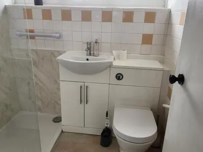 a bathroom with a white sink and a toilet at Beautiful two Bedroom house Entire house in Stevenage