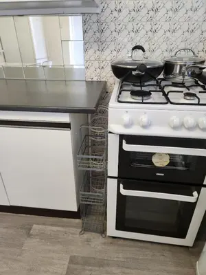 a kitchen with a stove with a pan on top of it at Beautiful two Bedroom house Entire house in Stevenage