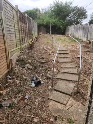 a garden with some stairs leading up to a fence at Beautiful two Bedroom house Entire house in Stevenage