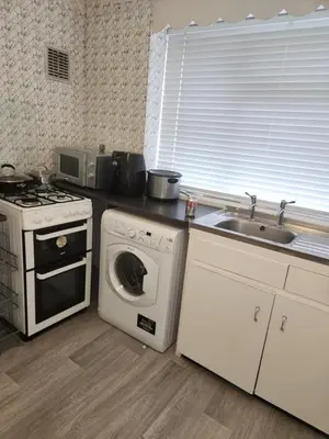 a kitchen with a washing machine and a sink at Beautiful two Bedroom house Entire house in Stevenage