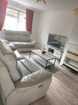 a living room with a couch and a tv at Beautiful two Bedroom house Entire house in Stevenage