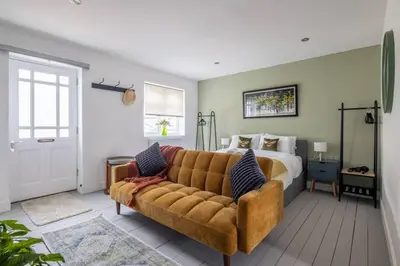 a bedroom with a couch and a bed at Modern Central Studio With Parking in Cambridge