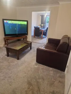 a living room with a flat screen tv and a couch at SK Short Let