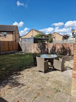 a patio with a table and chairs and a fence at SK Short Let