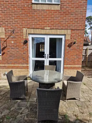 a table and chairs in front of a brick building at SK Short Let