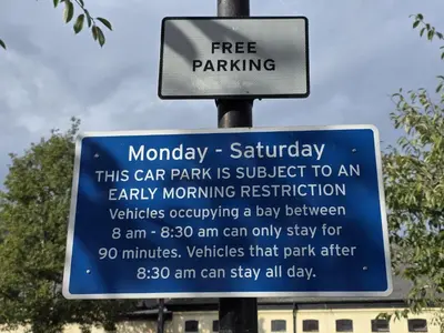 a sign for a car park is subject to an early morning restriction at Cozy One Bed Flat at Dawe Luxury Suites - An Entire Apartment near Ely Cathedral & Train Station - The Perfect Base to Explore Ely, Cambridge, Norfolk & London - 2 Guests Max & Pet Friendly in Ely