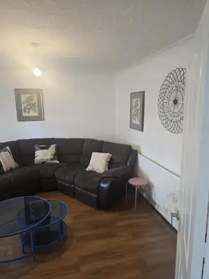 a living room with a couch and a table at Homely three bedroom in Vange