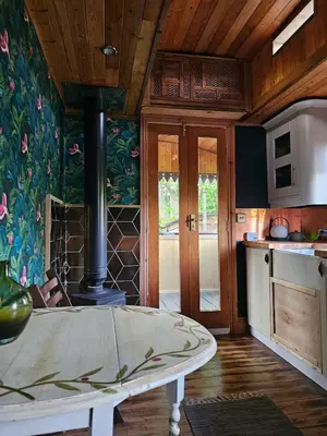 a kitchen with a stove in the middle of a room at offgrid showmans caravan in Kelvedon Hatch