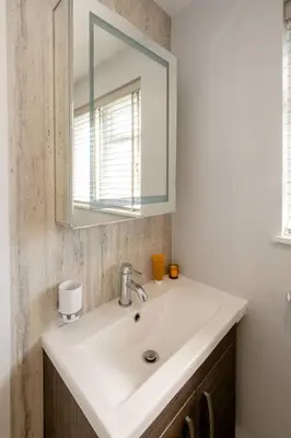 a bathroom with a white sink and a mirror at Rose Cottage, Blaxhall - Near Snape Maltings, Orford, Thorpeness & Aldeburgh - Aldeburgh Coastal Cottages in Blaxhall