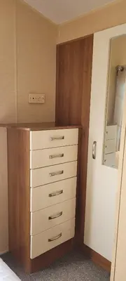 a bedroom with a dresser and a drawer with a mirror at Willerby Delux - Holiday Home by the Sea - close to the Entertainment Complex-bedding, towels & wifi Included! in Jaywick Sands