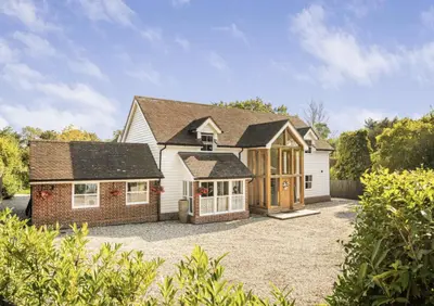 a large house with a garage in a yard at Mayrose House - 6BR 4BATH Luxe Spacious Retreat in Takeley