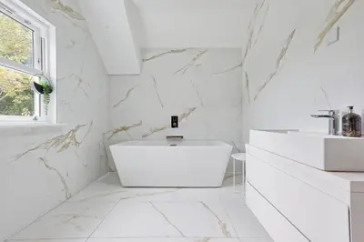 a white bathroom with a tub and a sink at Mayrose House - 6BR 4BATH Luxe Spacious Retreat in Takeley