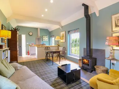 a living room with a couch and a stove at Clock Tower in Stowmarket