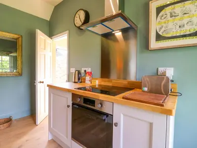 a kitchen with a sink and a stove top oven at Clock Tower in Stowmarket