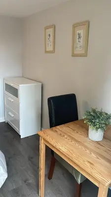 an office with a wooden table and a chair and a cabinet at Latchmead in Little Hallingbury