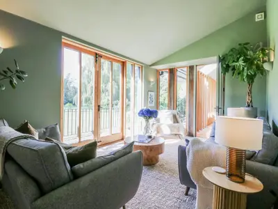 a living room with a couch and a table at Headland Barn in Maldon