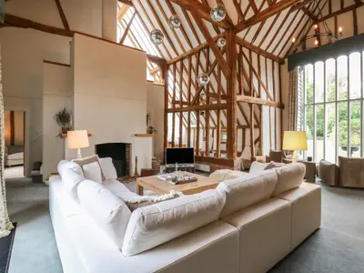 a large living room with a large white couch at Headland Barn in Maldon