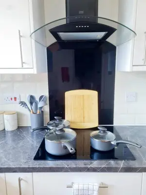 three pots on a stove in a kitchen at Chelmsford Getaway Business and Leisure