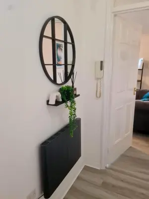 a room with a mirror and a plant on a wall at Chelmsford Getaway Business and Leisure